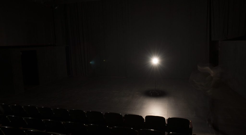 a light bulb on a bare stage